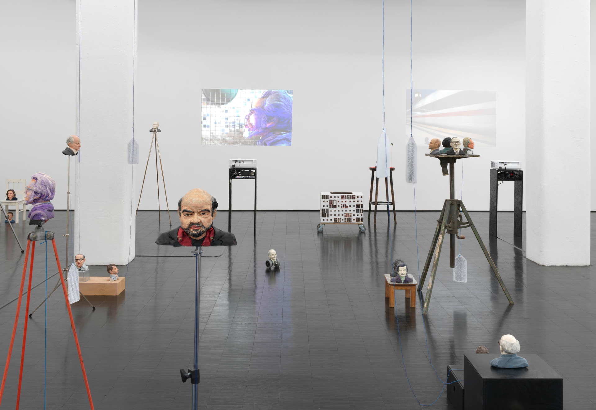 Heads, 2019 - 2021. 47 Plasticine busts, five HD videos (silent, various durations), wallpaper, various materials. dimensions variable