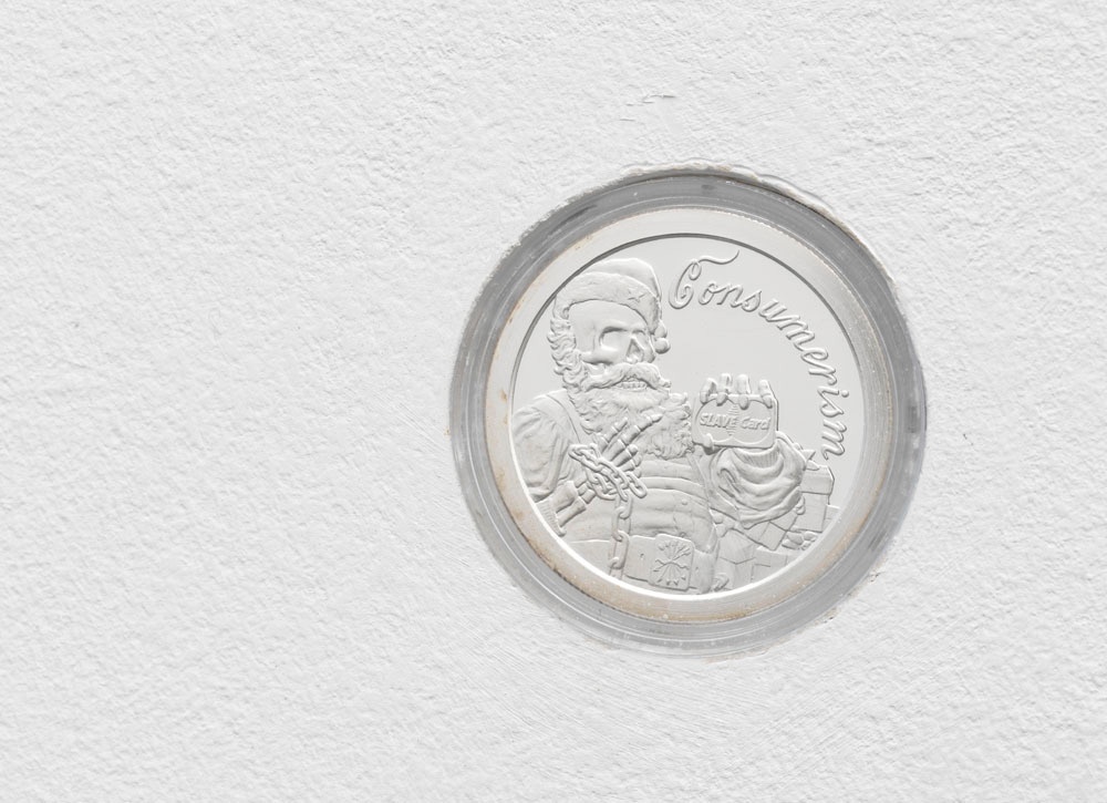 Silver Bullet Silver Shield Consumerism, 2014. silver coin. Ø 3.9 cm